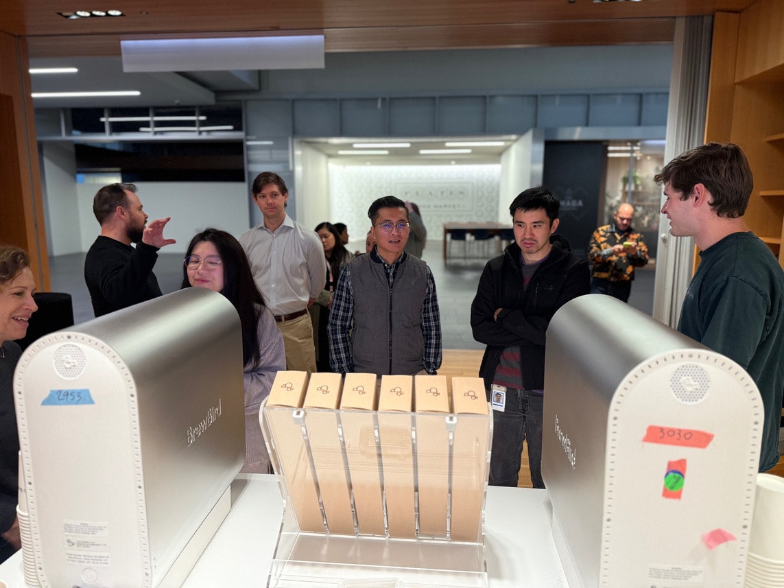 Tenants gathered around BrewBird coffee machines in the lobby
